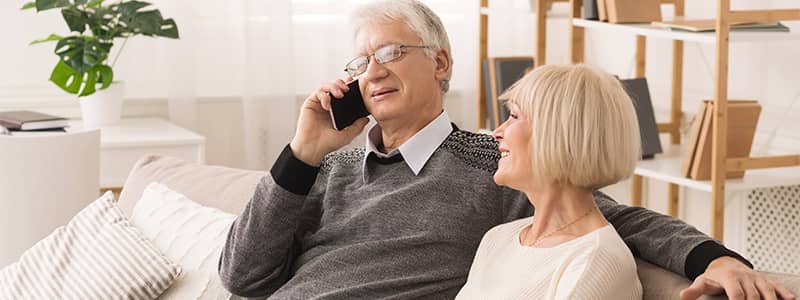 Older couple talking on telephone